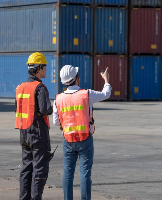 Foreman control loading containers box from cargo freight ship for import export, Foreman control industrial container cargo freight ship, Business import and export logistic concept.